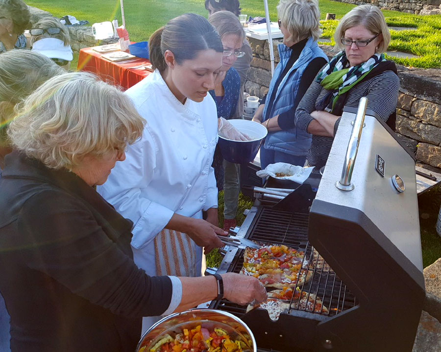 Deja Hart of Newport Cooks making Grilled Scallop-Pesto Pizza