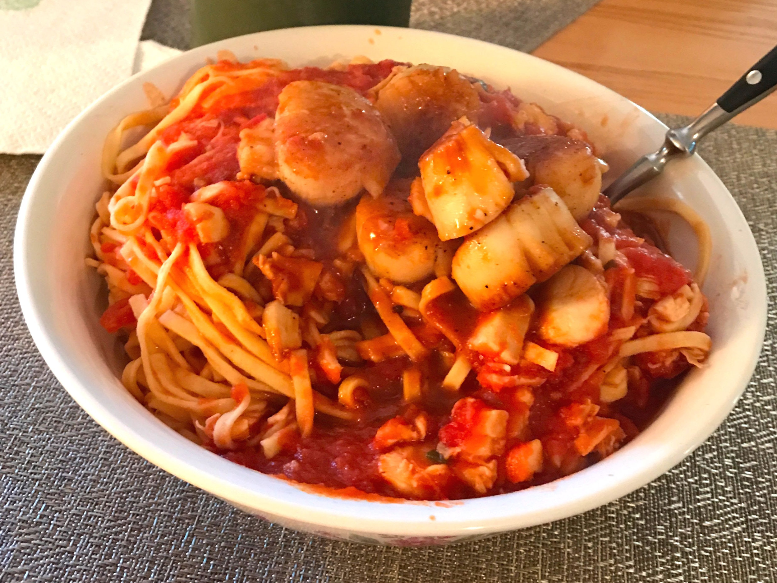 Scallops and Clams over fresh pasta with a spicy sherry tomato sauce